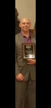 Group photo with Michael Polzin holding a Lake County Chamber of Commerce recognition plaque.